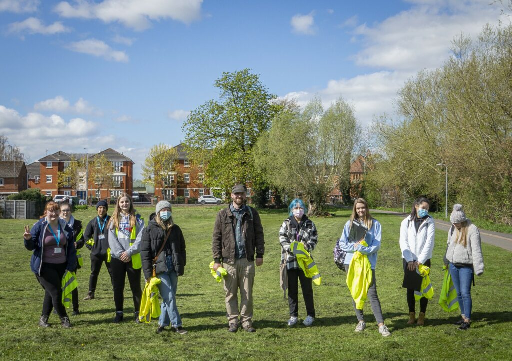 a group of a dozen students and their lecturer about to commence fieldwork surveying the public at Duck Brook