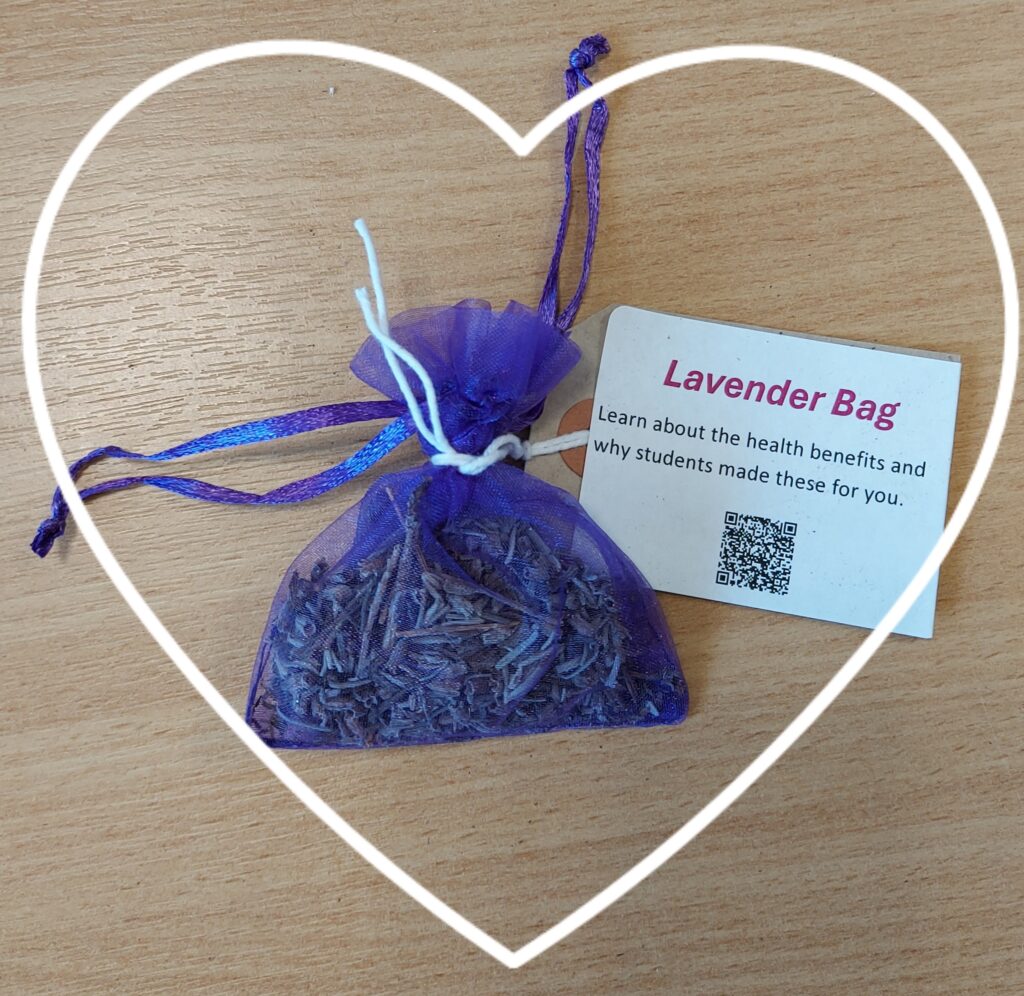 Photograph of small lavender bag with card board label surrinded by a white heart
